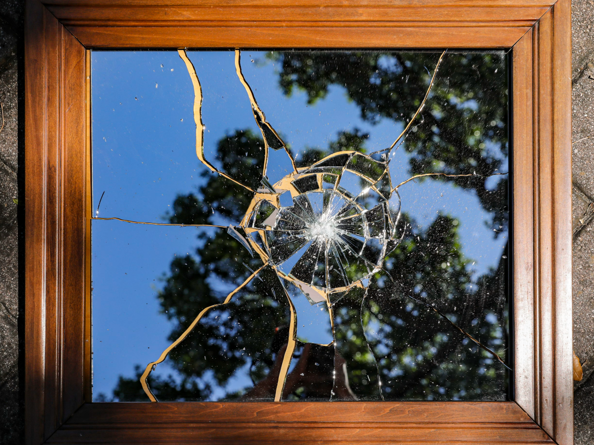 Reference fidelity test original: a framed mirror with shattered glass