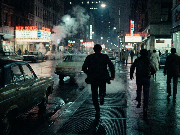 Cinematic tracking shot of a man running on a street, showcasing the precise motion and camera control features of KlingAI O1.